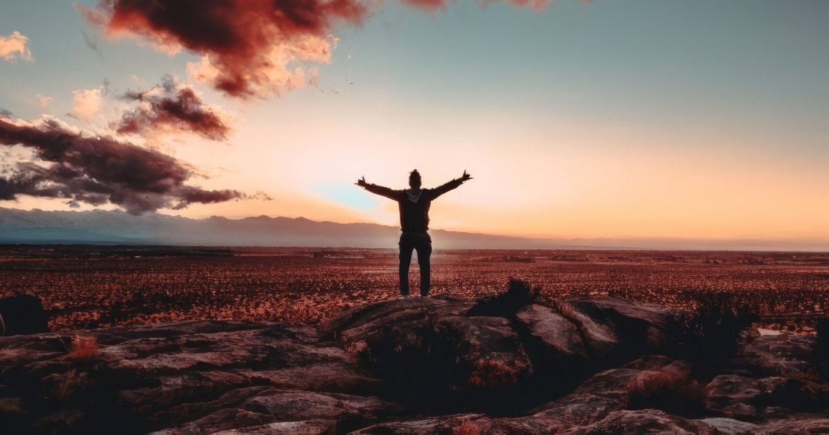 man standing in an open area during a sunrise, ready to face the world