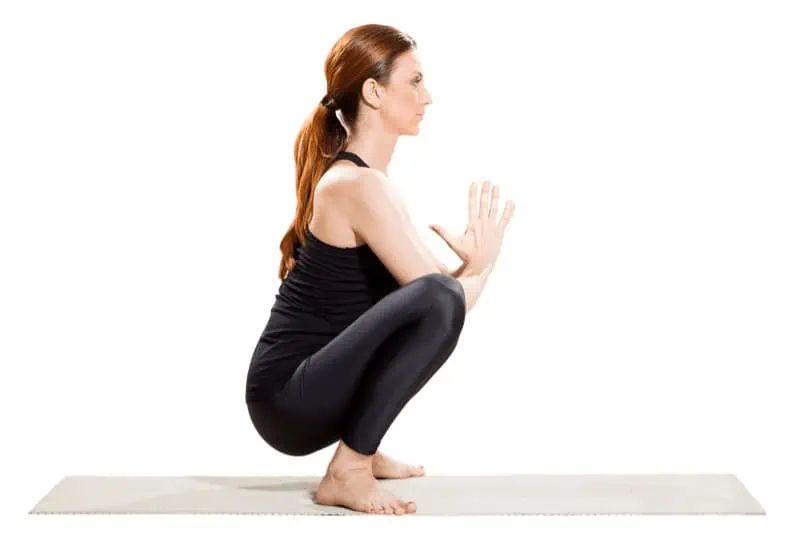 Before Mandukasana, warm up your hips with poses like Malasana (Yogi Squat).